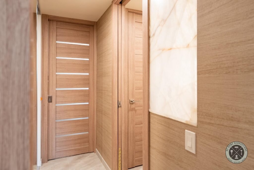 Modern wood interior doors with frosted glass inserts installed during a luxury home remodel in Orange County.